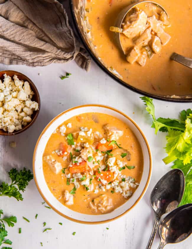 overhead image of Buffalo chicken soup topped with blue cheese in a bowl