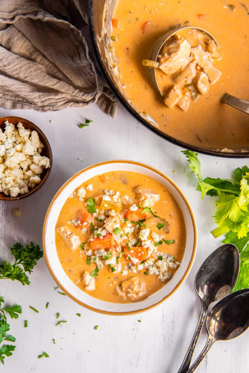 overhead image of Buffalo chicken soup topped with blue cheese in a bowl