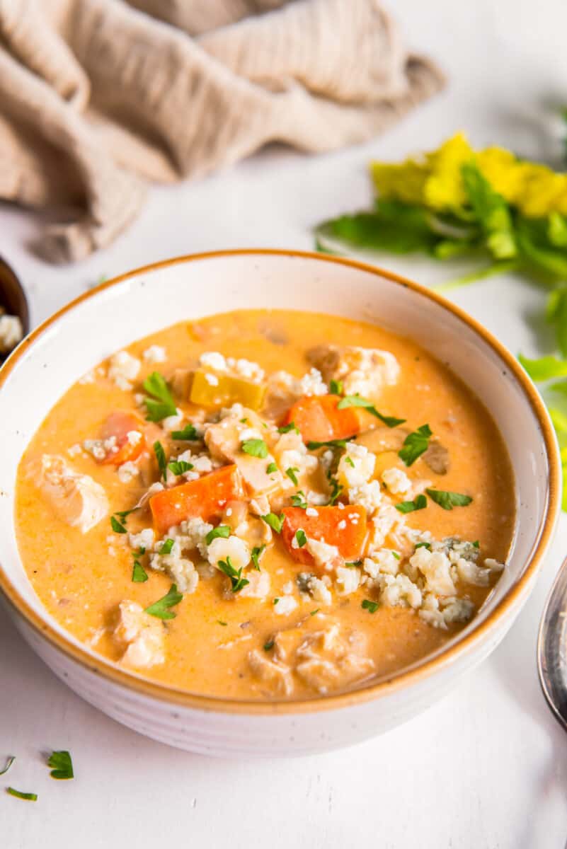 Buffalo chicken soup topped with blue cheese in a bowl