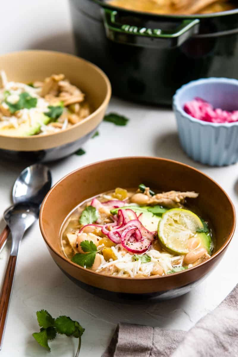 green chile chicken soup in a tan bowl