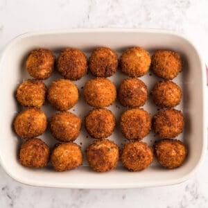chicken parmesan meatballs in a baking dish