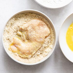 chicken breast coated in flour and eggs in seasoned breadcrumbs mixture