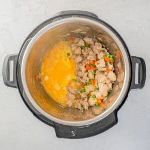 eggs added to instant pot with chicken, carrots, and peas