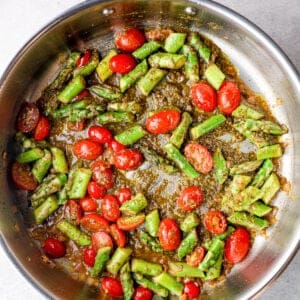 tomatoes and asparagus in a skillet