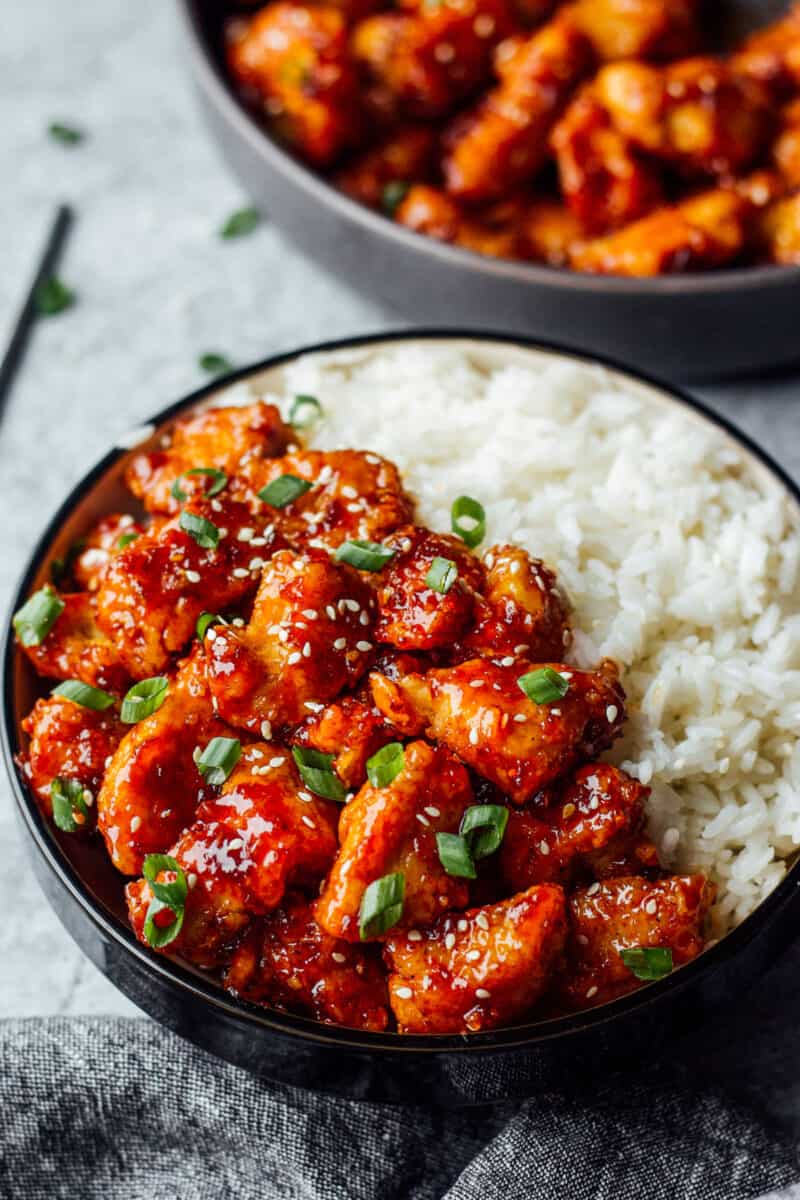 korean fried chicken with white rice in a bowl