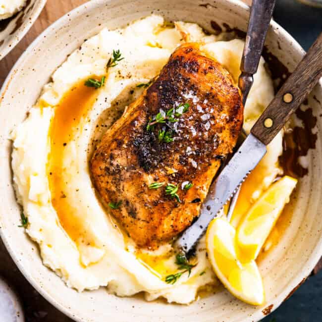 overhead view of a serving of crockpot lemon chicken over mashed potatoes.