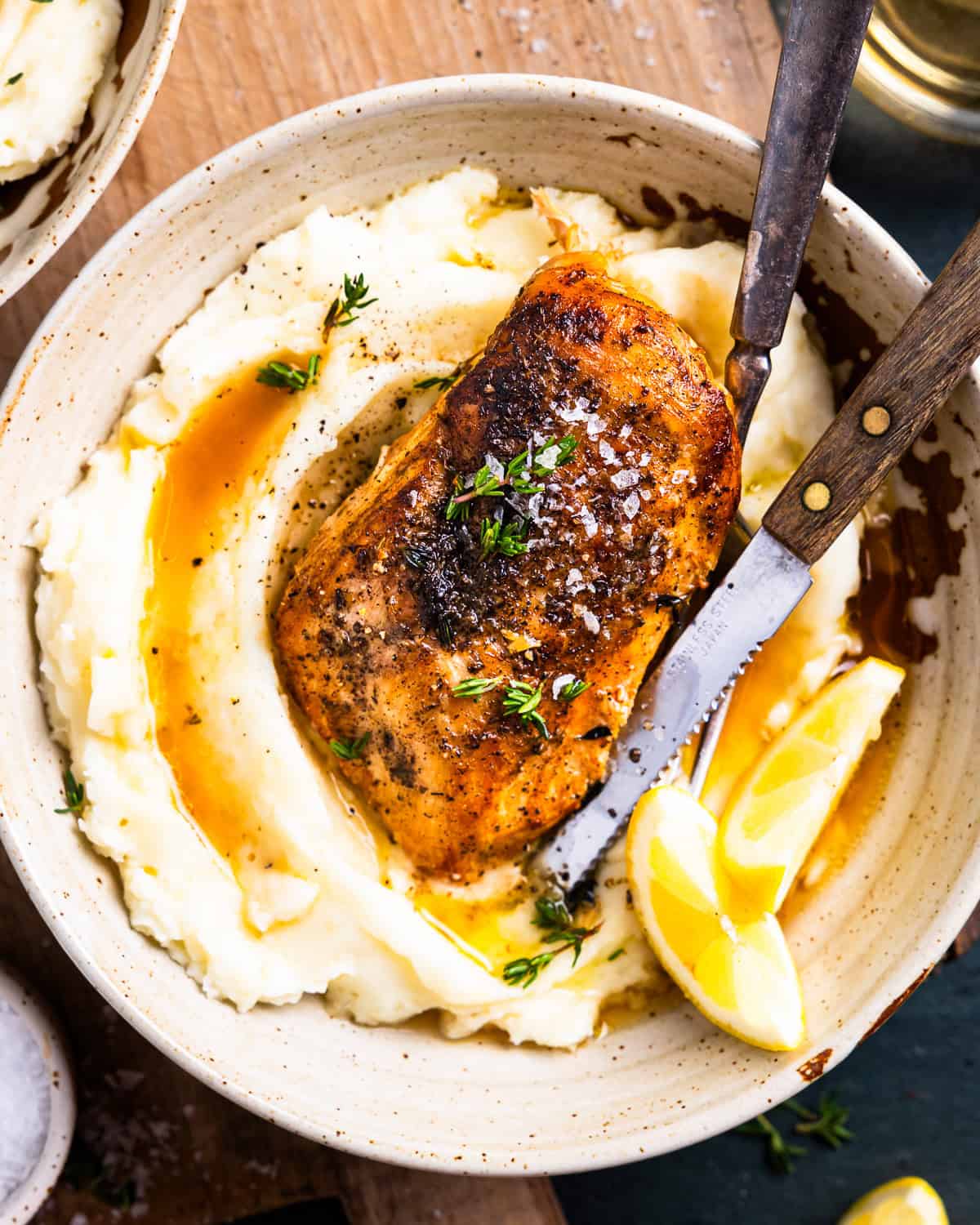 overhead view of a serving of crockpot lemon chicken over mashed potatoes.