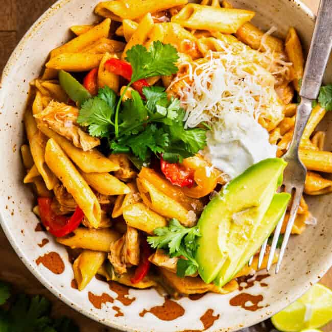 overhead view of a bowl of instant pot chicken fajita pasta with a fork.