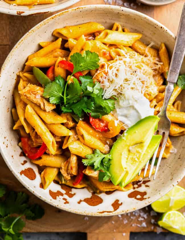 overhead view of a bowl of instant pot chicken fajita pasta with a fork.