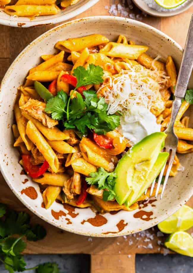 overhead view of a bowl of instant pot chicken fajita pasta with a fork.