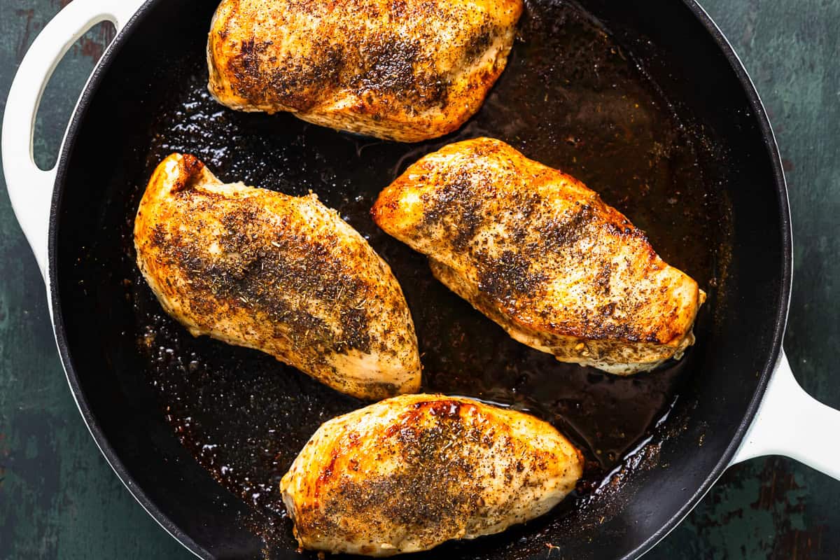 seared chicken breasts in a pan.