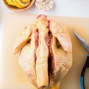 spatchcock chicken on a cutting board