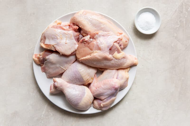 cut up chicken on a plate with salt