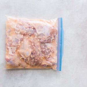 chicken marinating in a plastic ziptop bag