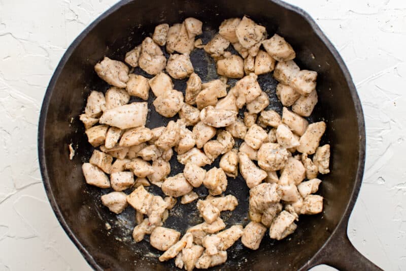 cooked chicken pieces in a skillet