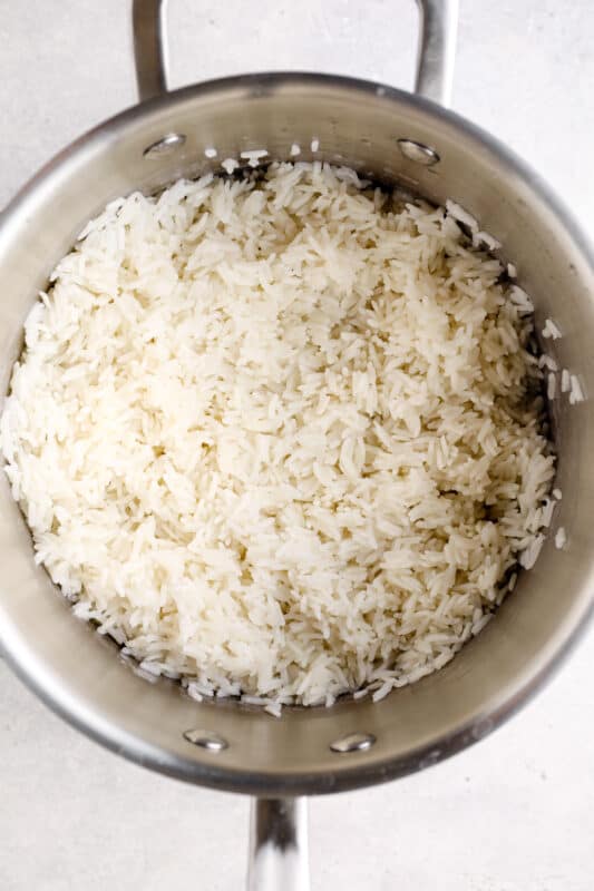 overhead view of cooked white rice in a saucepan.