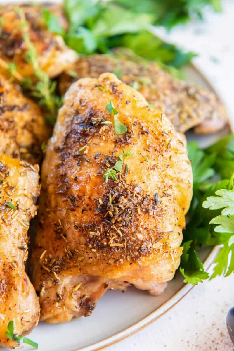 baked chicken thighs on a white serving platter