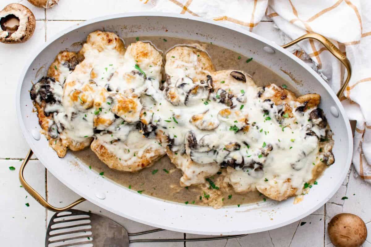 overhead image of chicken lombardy in a white baking dish after baking