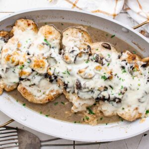 overhead image of chicken lombardy in a white baking dish after baking