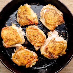 cooked chicken thighs in a skillet