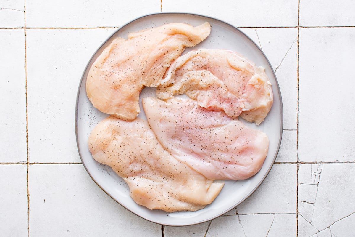 seasoned chicken breasts on a white plate