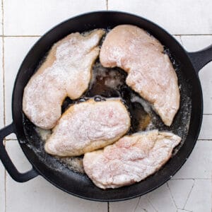 cooking chicken breasts in a skillet