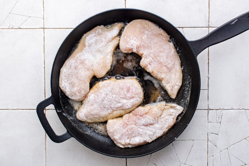 cooking chicken breasts in a skillet