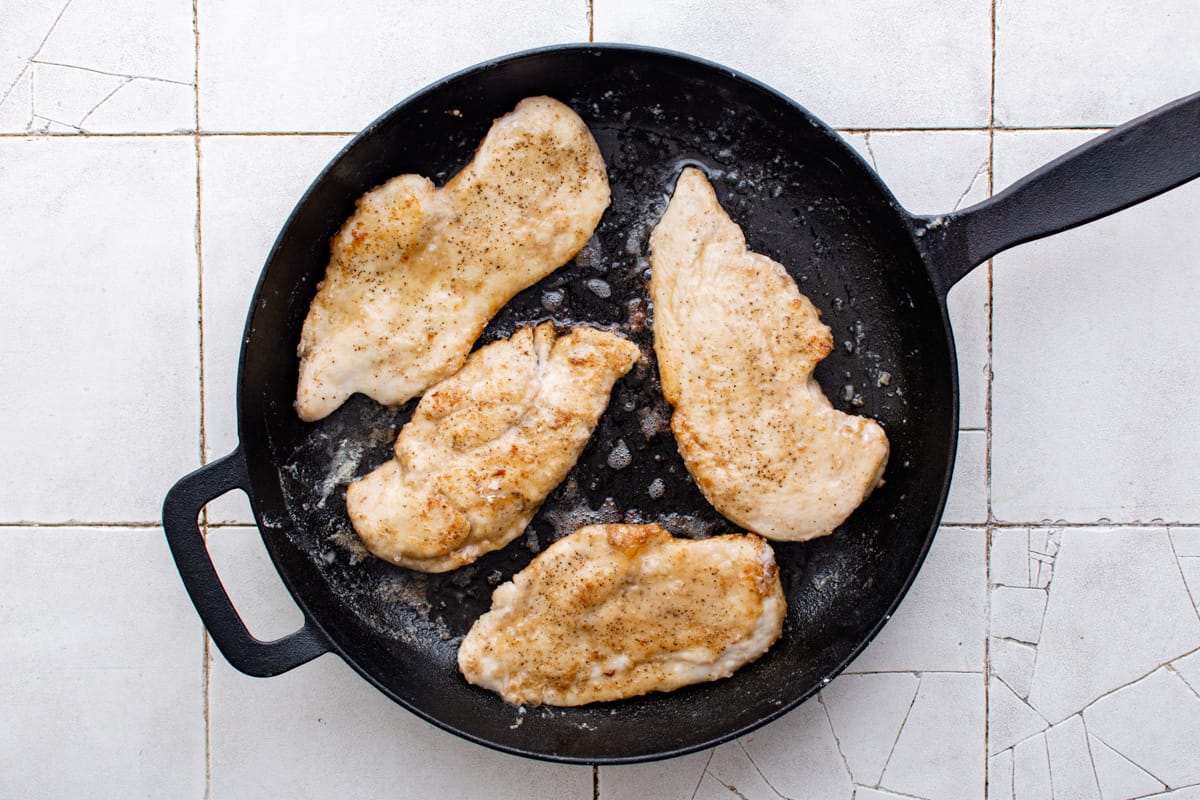 cooking chicken breasts in a skillet