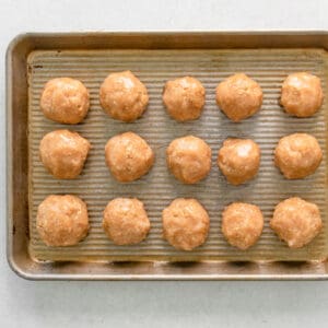 chicken meatballs before baking on a baking sheet