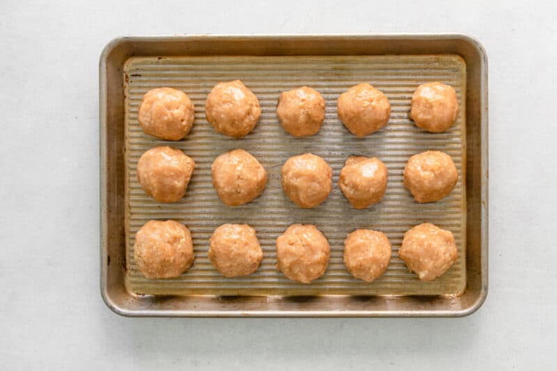 chicken meatballs before baking on a baking sheet