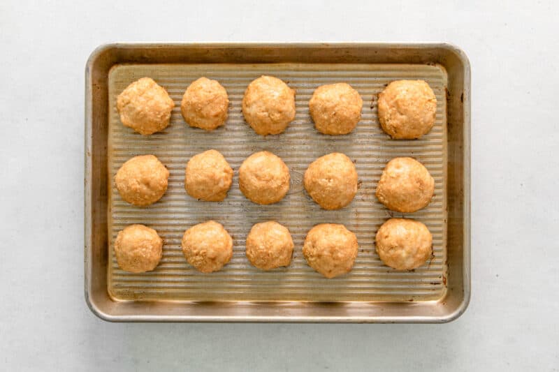 chicken meatballs on a baking sheet after baking