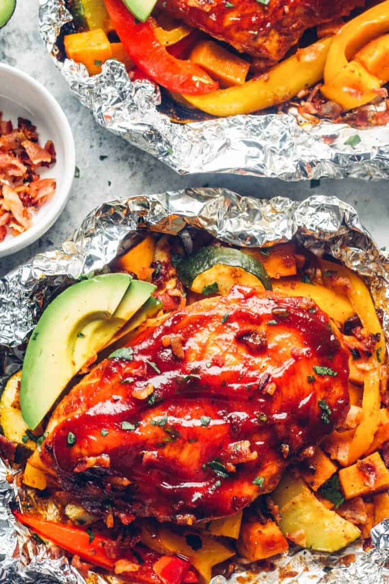 bbq chicken foil packets with avocado slices and bacon.