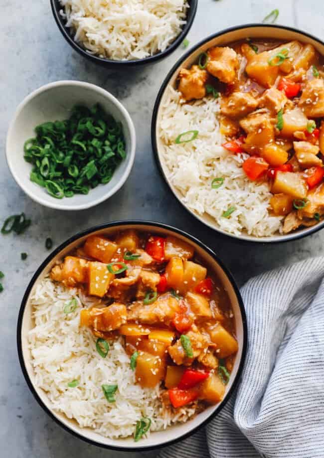 crockpot hawaiian chicken in black and white bowls with rice.