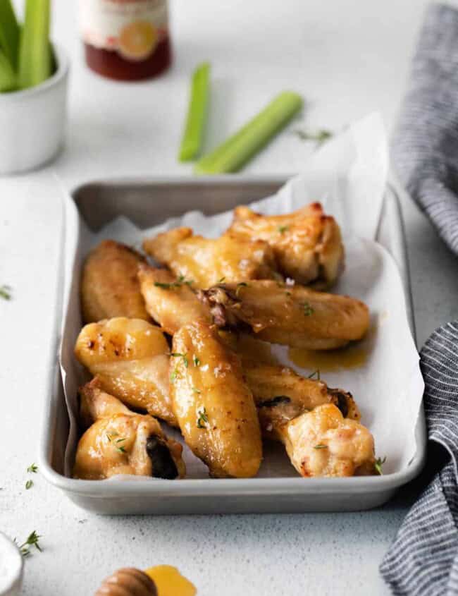 10 hot honey chicken wings on a baking sheet.