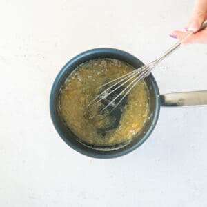 butter and garlic in a saucepan with a whisk.