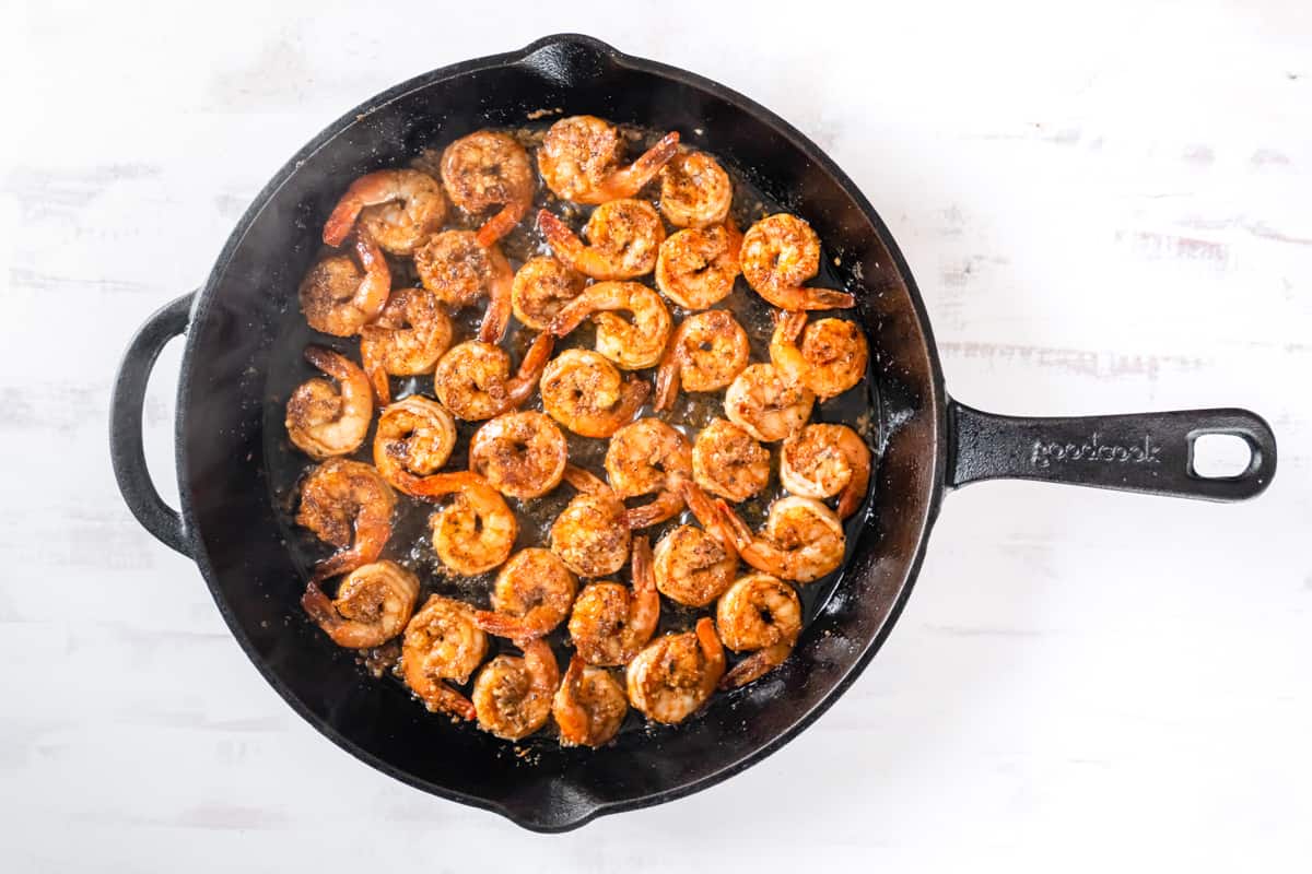 shrimp cooking in a cast iron skillet.