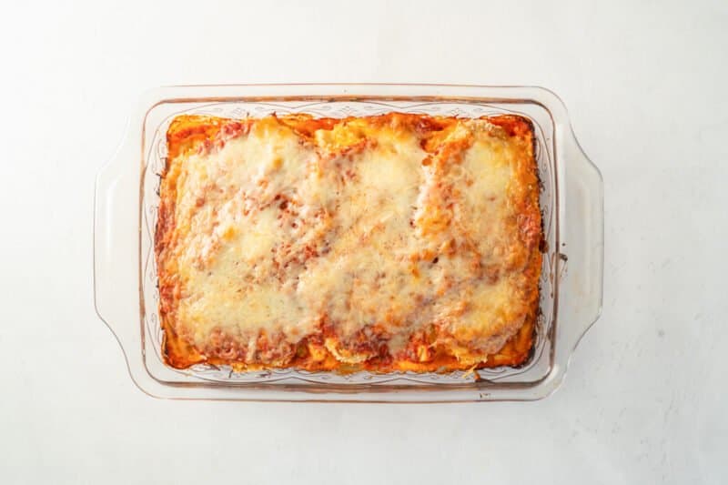 fully baked chicken parmesan lasagna in a glass baking dish.