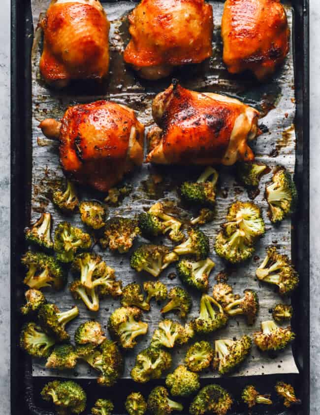 broccoli and 5 chicken thighs on a sheet pan.