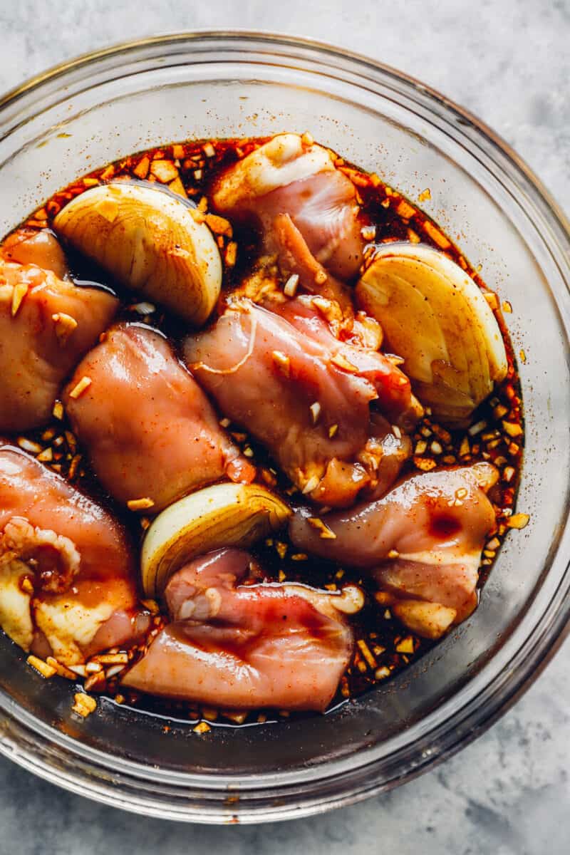a clear bowl filled with chicken and balsamic marinade
