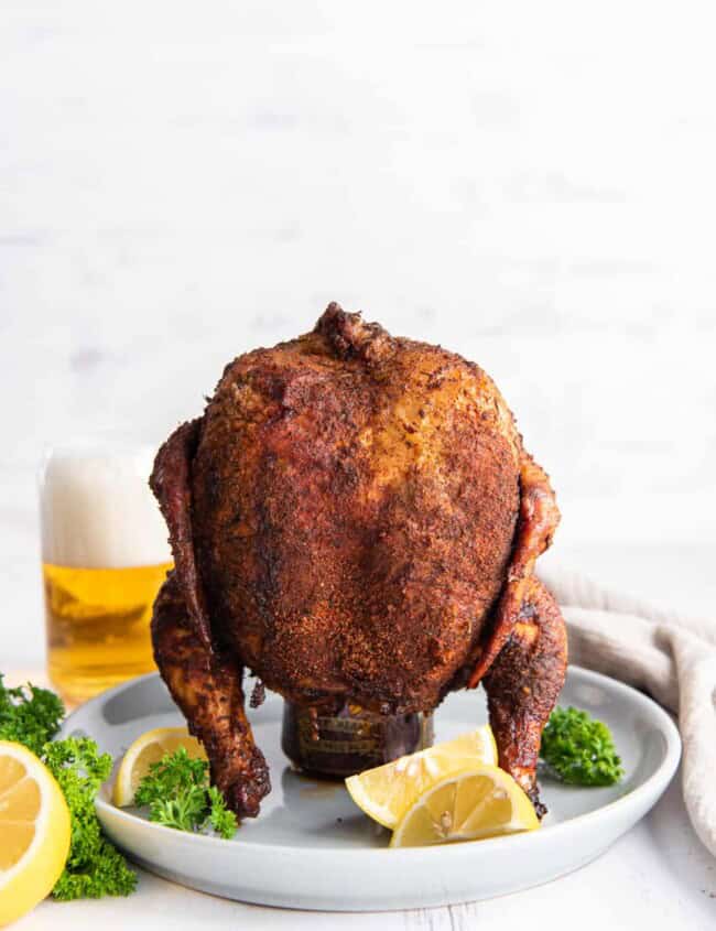 beer can chicken on a white serving plate.