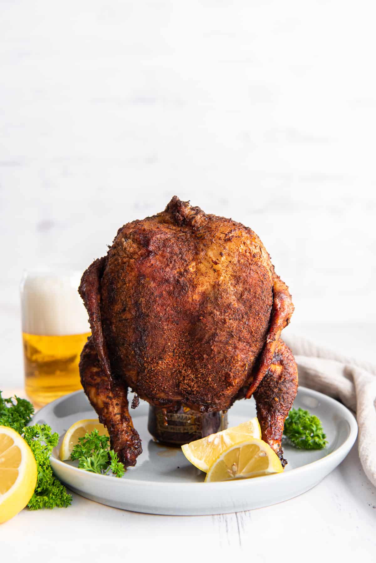 beer can chicken on a white serving plate.