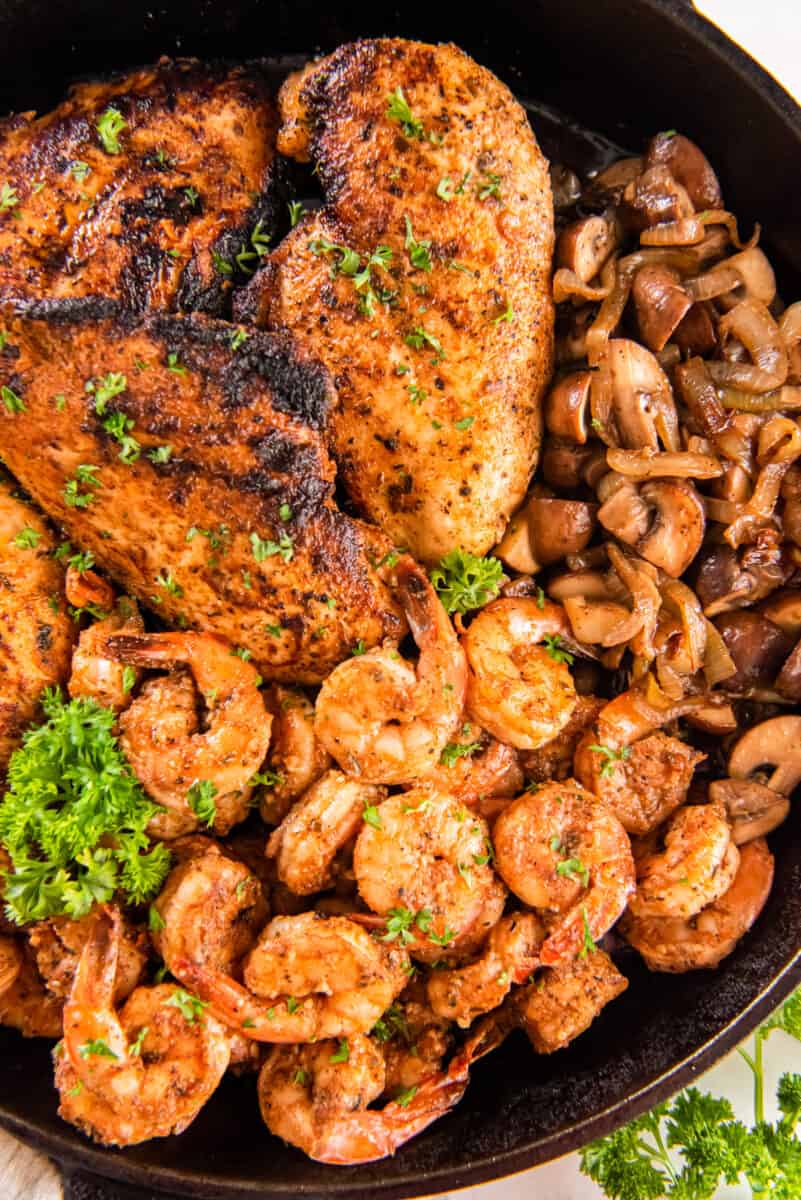 overhead view of applebees bourbon street chicken and shrimp in a skillet.