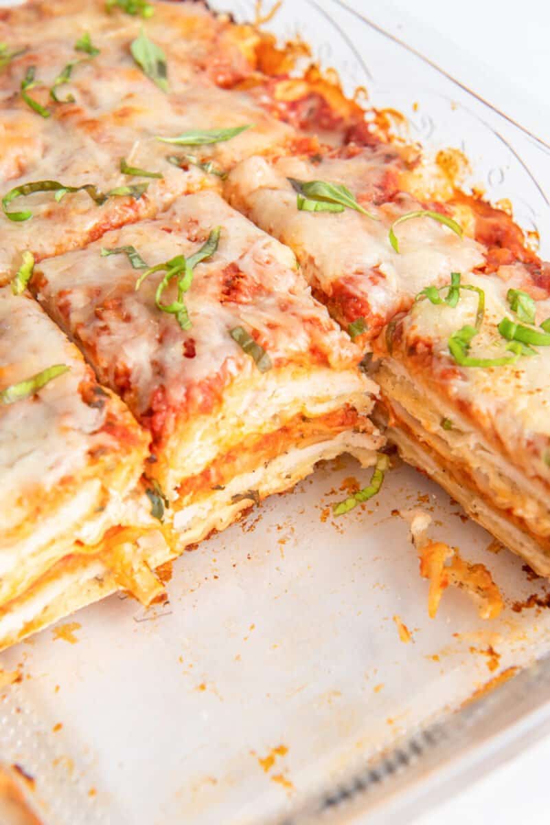sliced chicken parmesan lasagna in a glass baking dish.