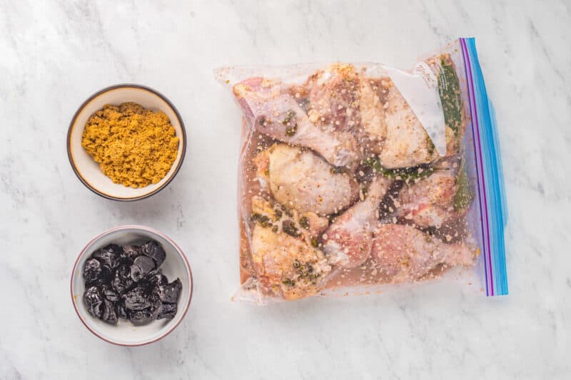 chicken pieces marinating in a ziplock bag.