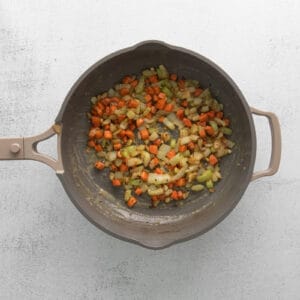 mirepoix with garlic and thyme in a frying pan.