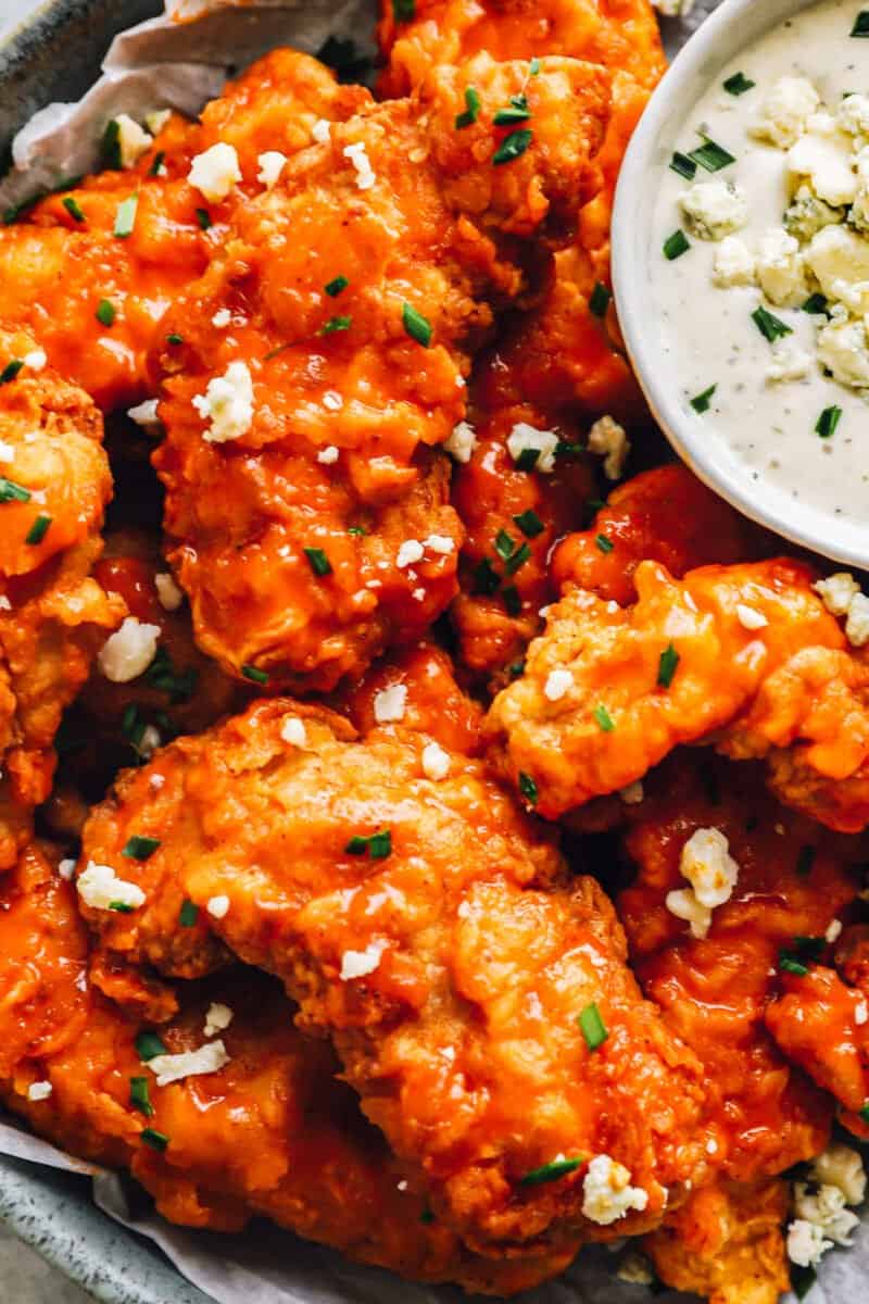 close up of buffalo chicken tenders with ranch sauce.