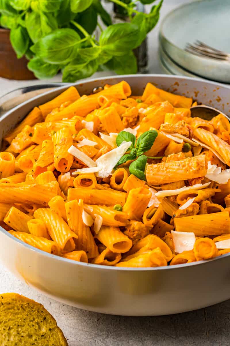 chicken rigatoni in a skillet with basil.