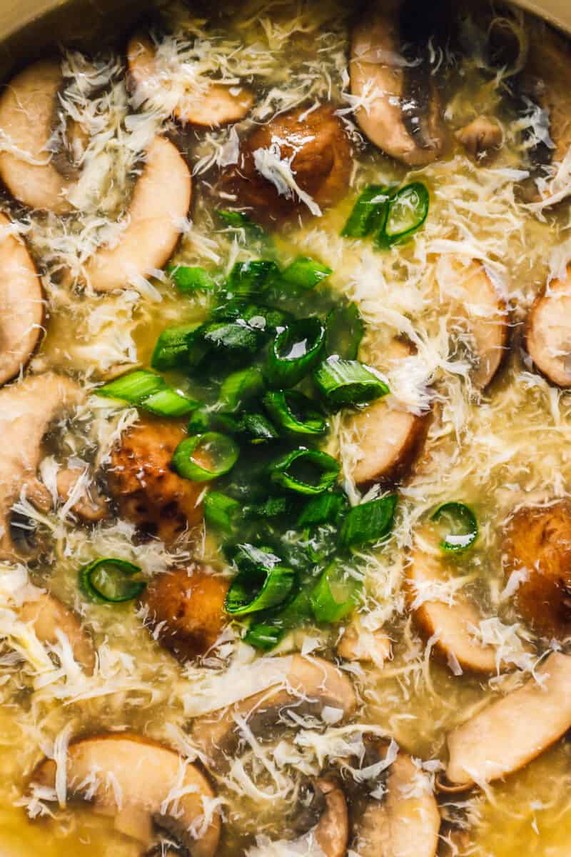 close up on a bowl of egg drop soup with mushrooms