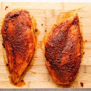 two chicken breasts on a cutting board