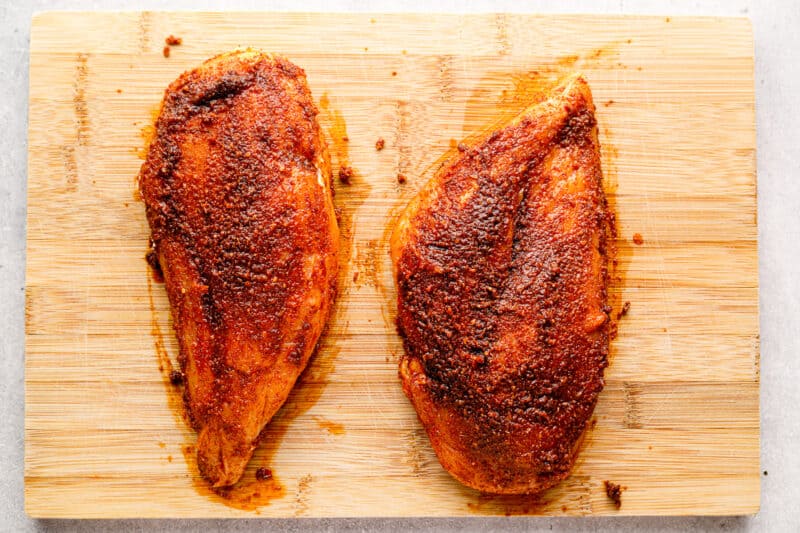two chicken breasts on a cutting board